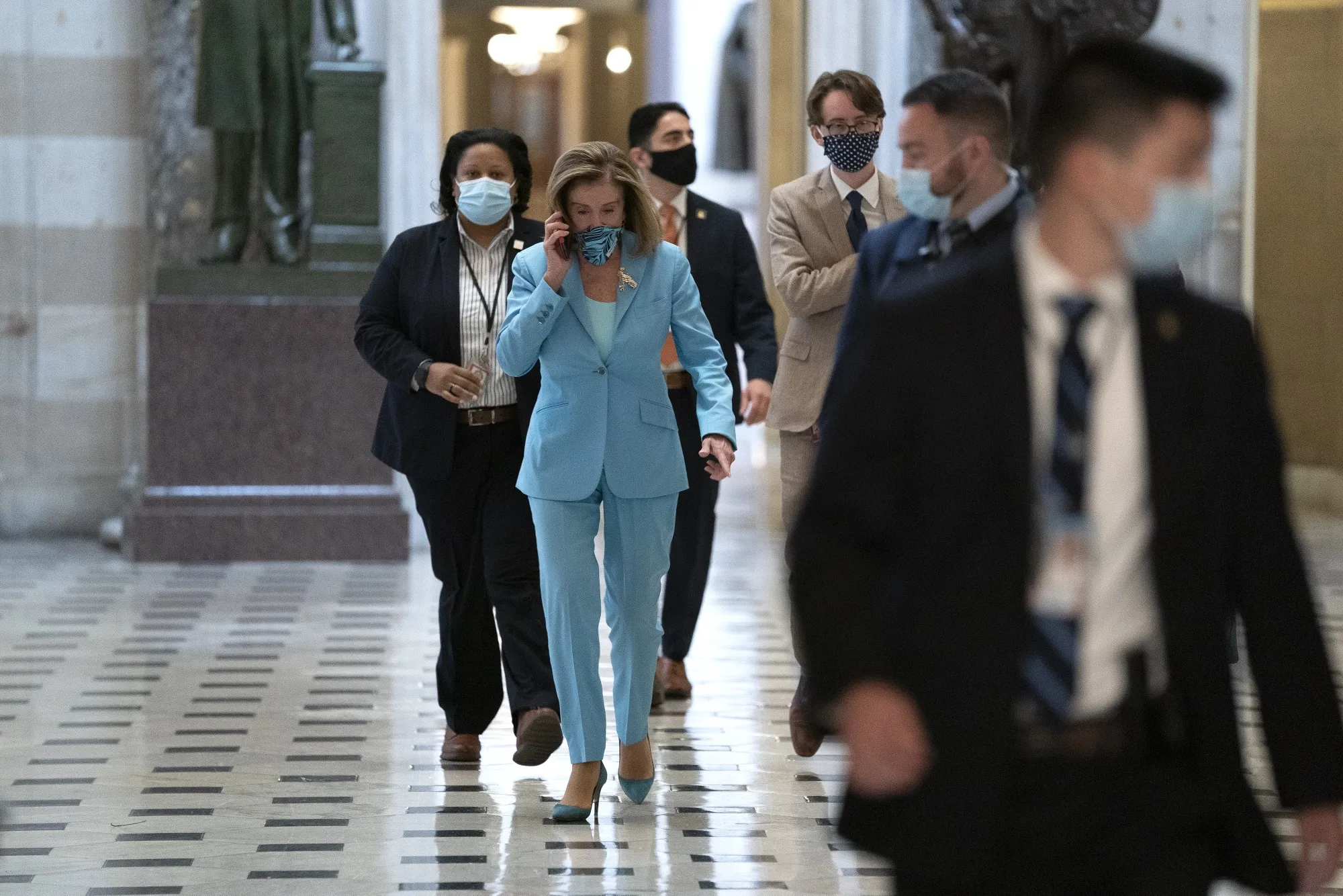Nancy Pelosi speaks on the phone as she walks through the U.S. Capitol in Washington, D.C. on Sept. 15.