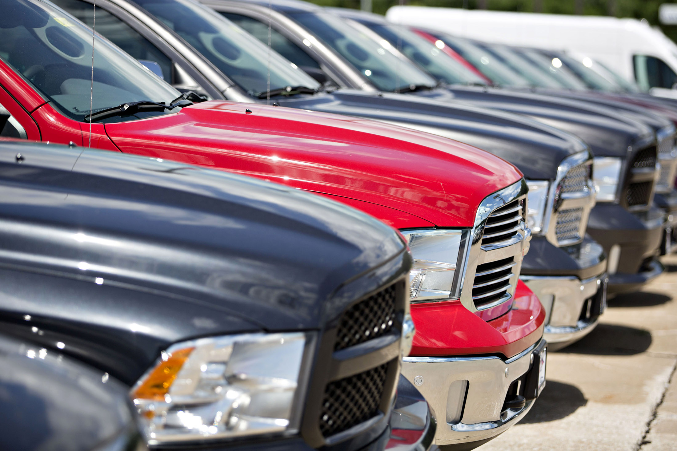 A row of Fiat Chrysler Automobiles (FCA) 2017 Dodge Ram trucks are displayed for sale at a car dealership in Moline, Ill.