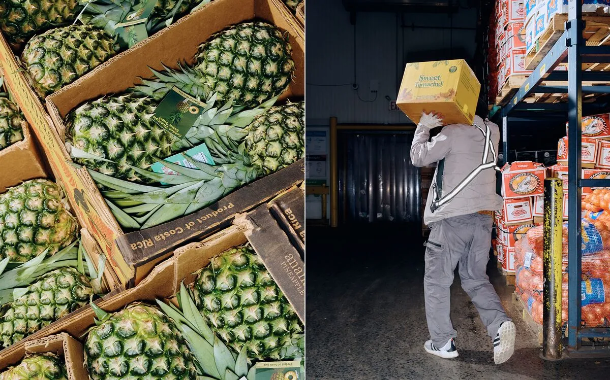 A worker loads produce into the back of a truck.