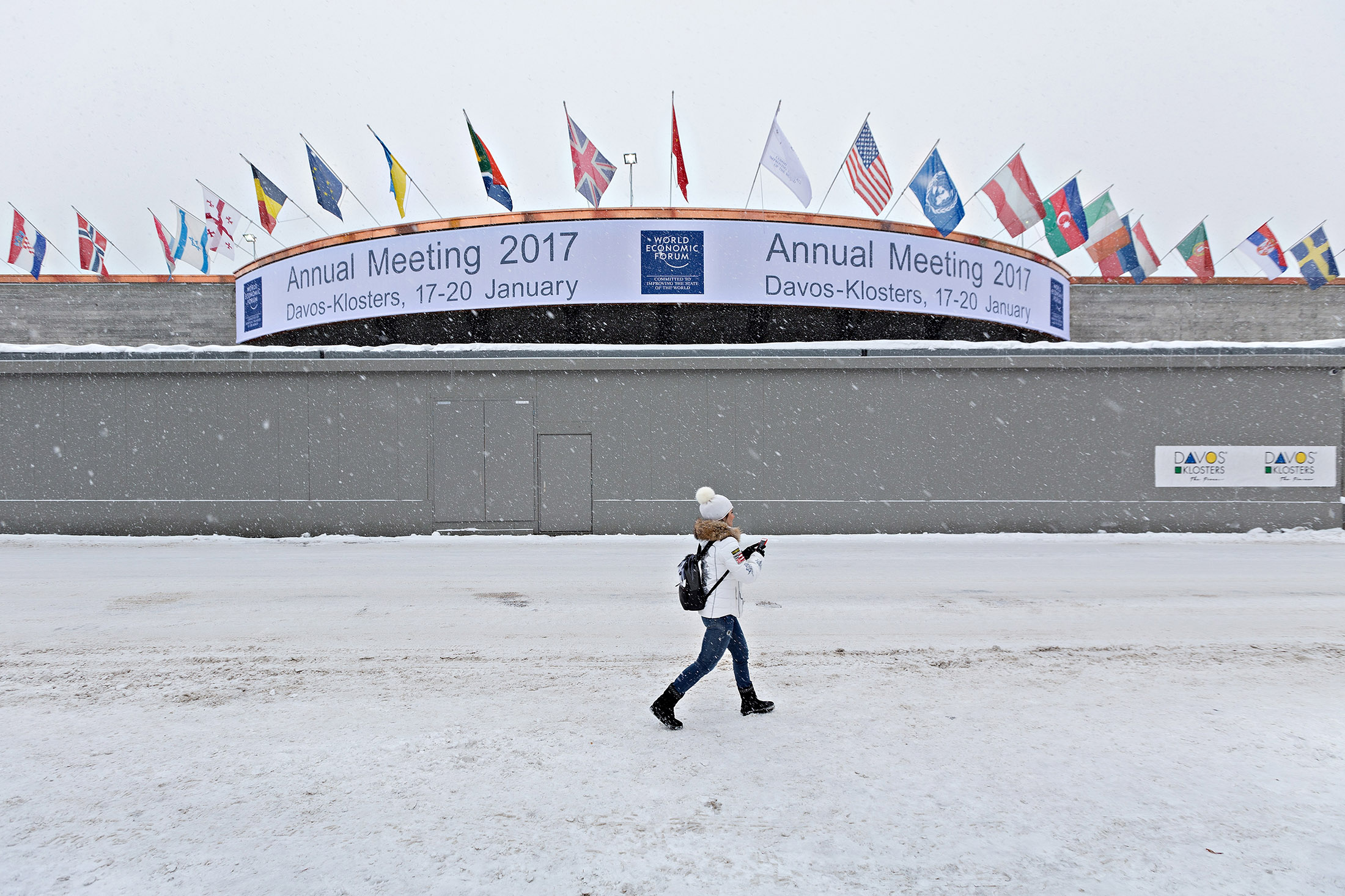 A woman walks past the entrance to the Congress Center, venue for the World Economic Forum (WEF), in Davos on Jan. 13, 2017.
