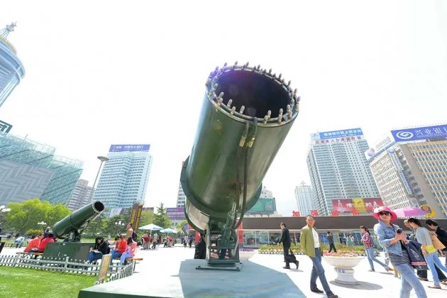 Pedestrians walk past two giant sprayers set up to lower dust and smog at the Dongfanghong Square in Lanzhou city, northwest Chinas Gansu province on May 5