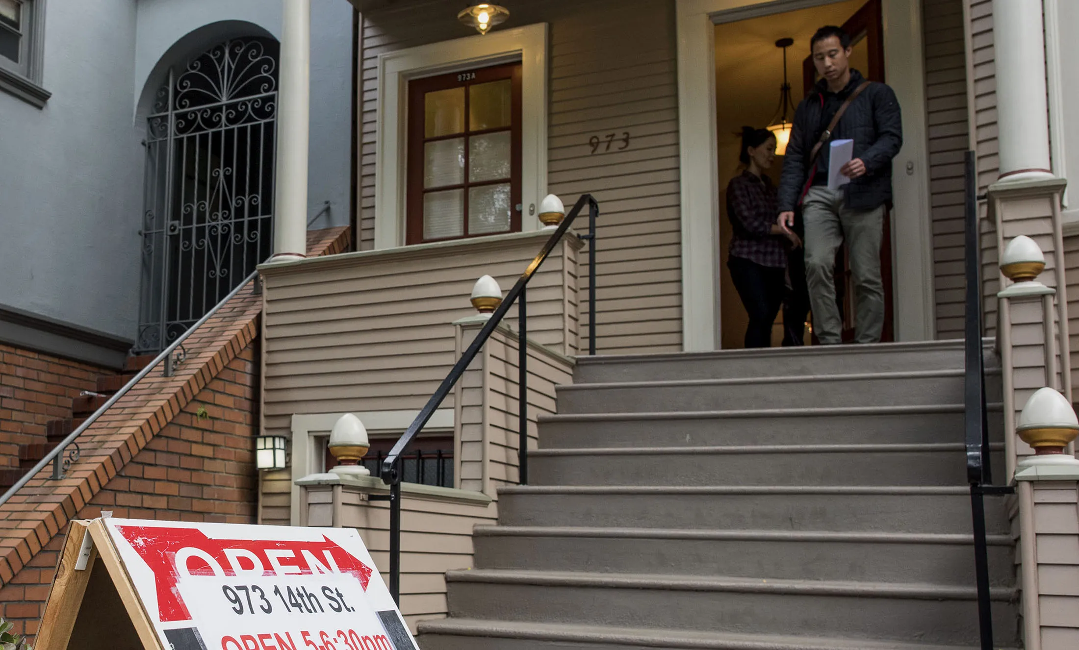 Potential buyers exit a home for sale near San Francisco, California.
