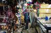 A shopper looks at a sarong in the Filipino Market in Kota Kinabalu, Sabah, Malaysia, on Saturday, July 29, 2017. Sabah and neighboring Sarawak are known in Malaysia as "fixed deposits" for Barisan Nasional. They have long supported the establishment, accounting for about a third of the coalition's seats at the last general election.