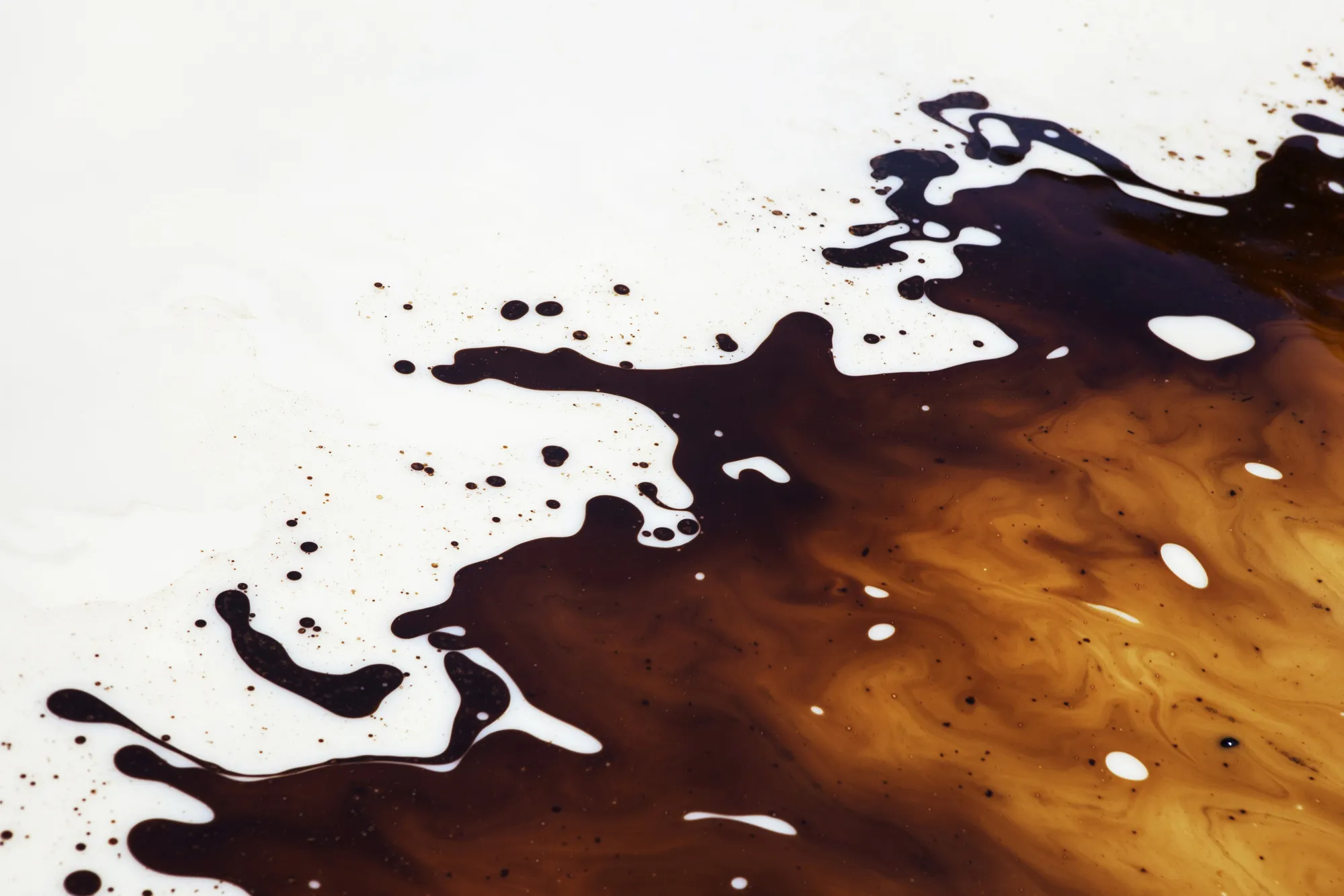 Oils sit on water inside a cleaning pond at a petroleum plant in Sindh, Pakistan.