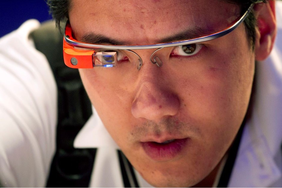 Vincent Nguyen, Editor in Chief of SlashGear, wears Google Glass while covering the introduction of the Microsoft Surface 2, Monday, Sept. 23, 2013 in New York.