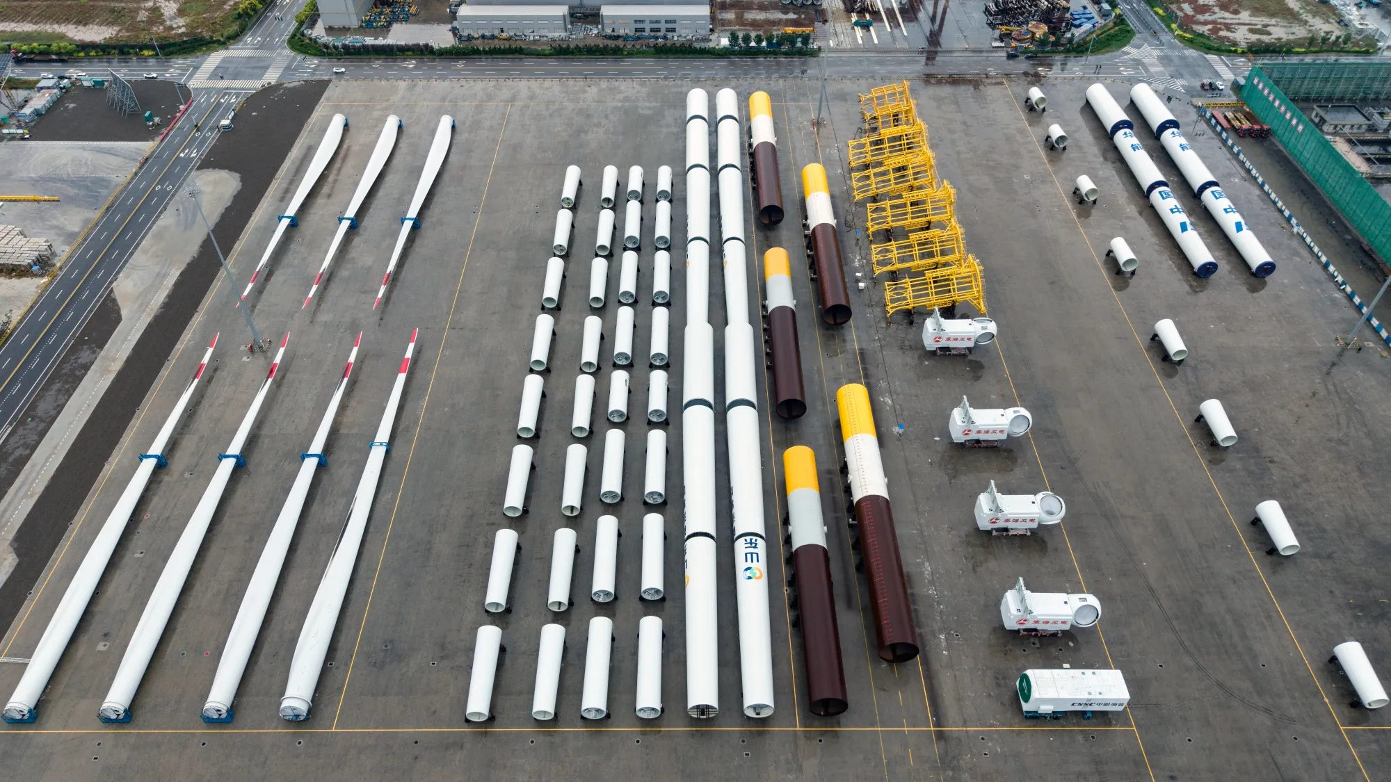 Components for offshore wind turbines waiting to be loaded onto ships at the Dongying Offshore Wind Power Equipment Industrial Park in Dongying, Shandong province.