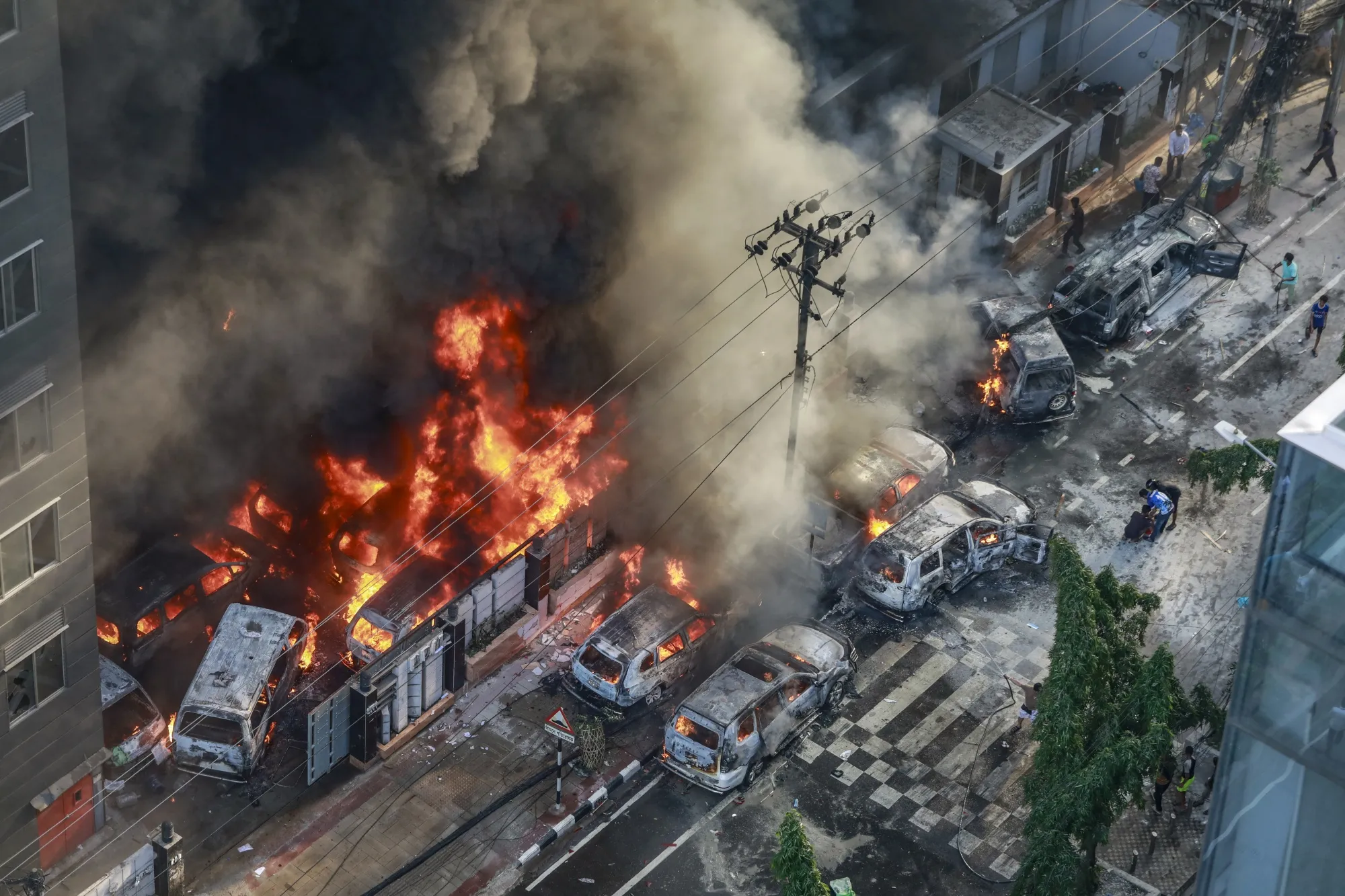 Smoke rises from the burning vehicles after protesters set them on fire during the a protest in Dhaka on July 18.