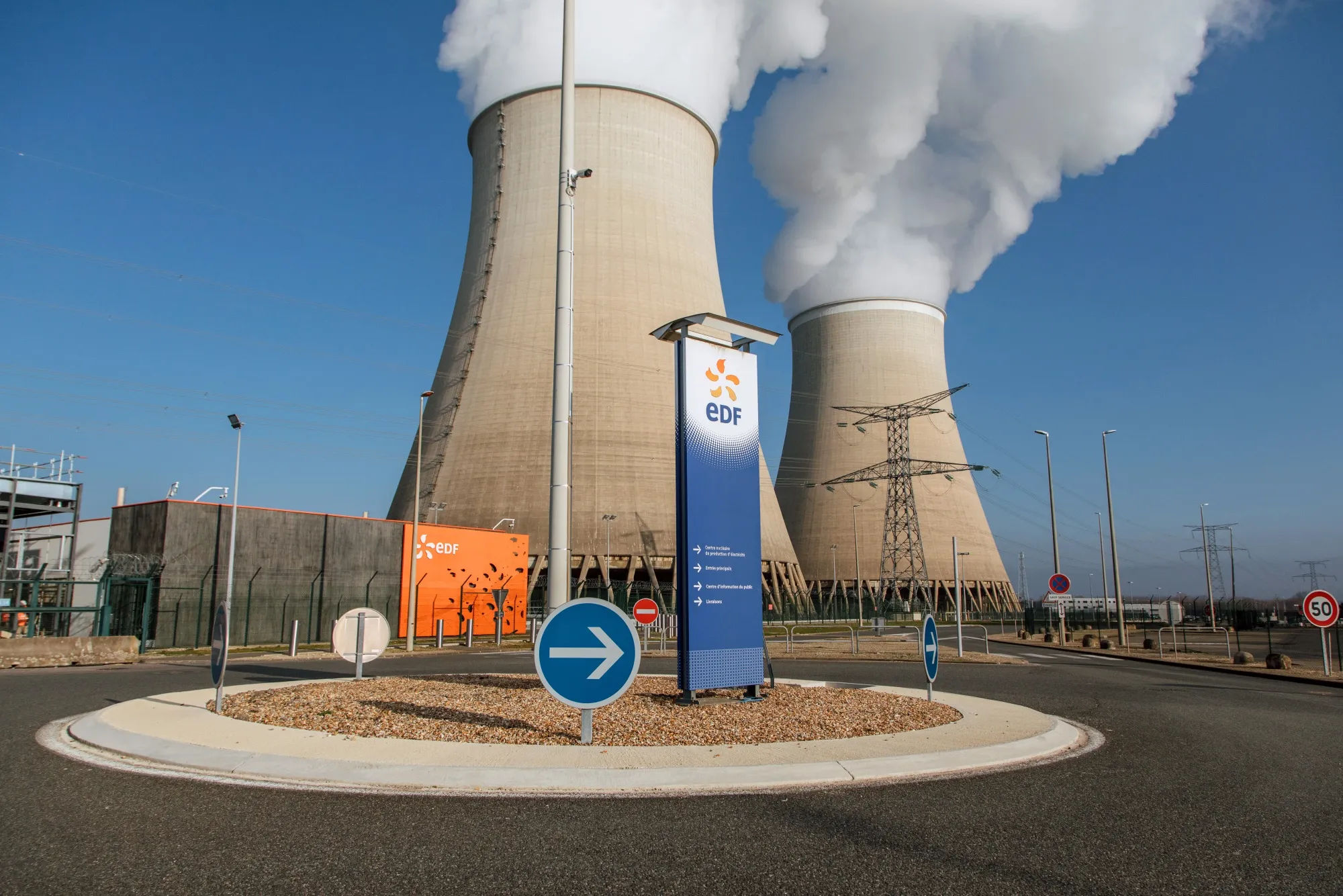 Cooling towers release water vapor at the Nogent nuclear power plant, operated by Electricite de France SA, in Nogent-sur-Seine, France.