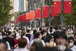 Pedestrians walk down Nanjing Road in Shanghai, China.