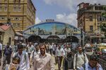 Commuters exit Masjid Bunder train station in Mumbai.
