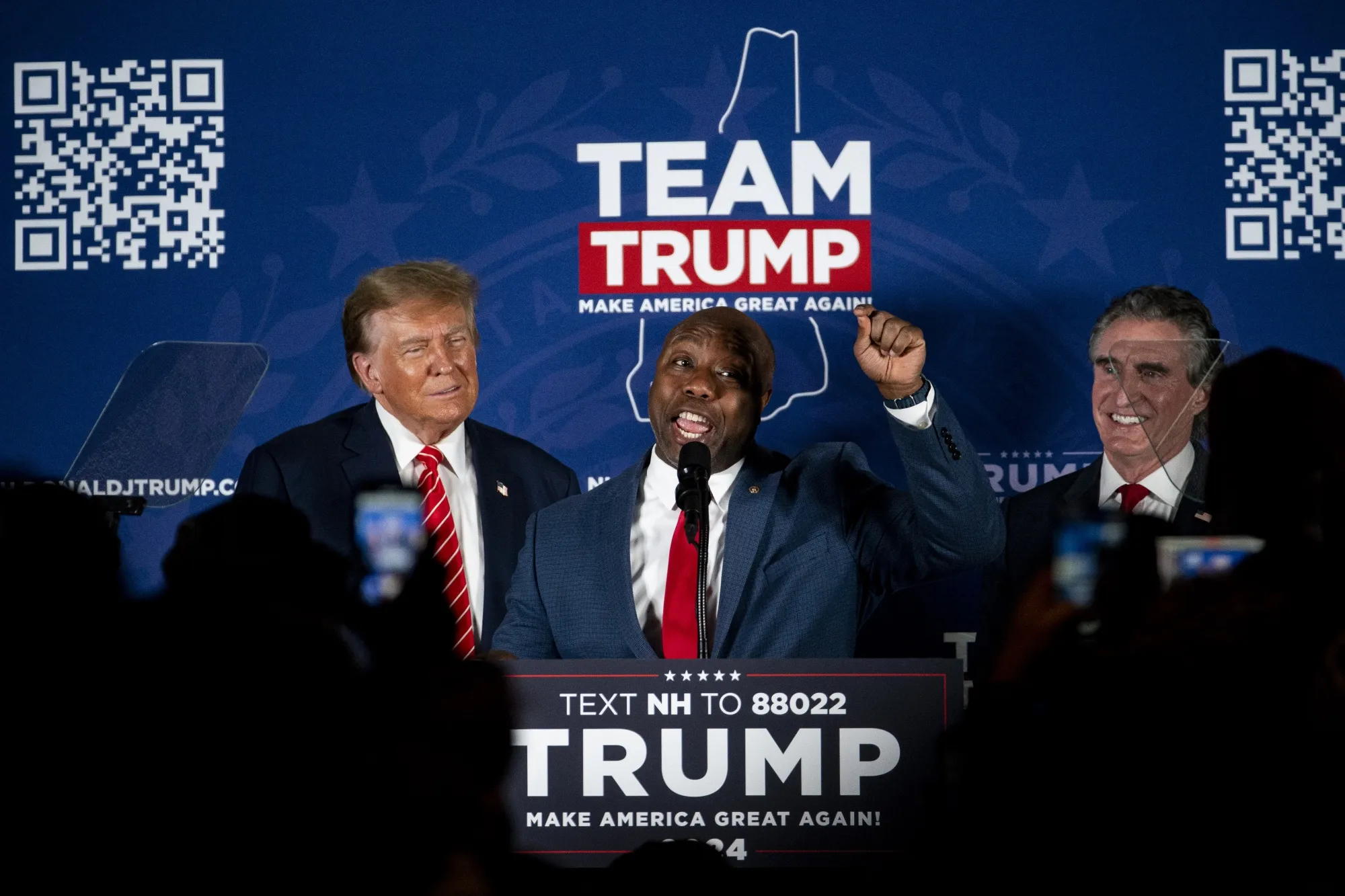 Senator Tim Scott, a Republican from South Carolina, center, speaks during a campaign event with former US President Donald Trump, left, and Doug Burgum, governor of North Dakota, right, in Laconia, New Hampshire in January.