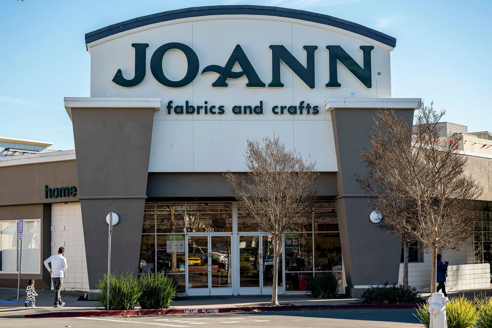 arafed view of a joann store with a man walking in front