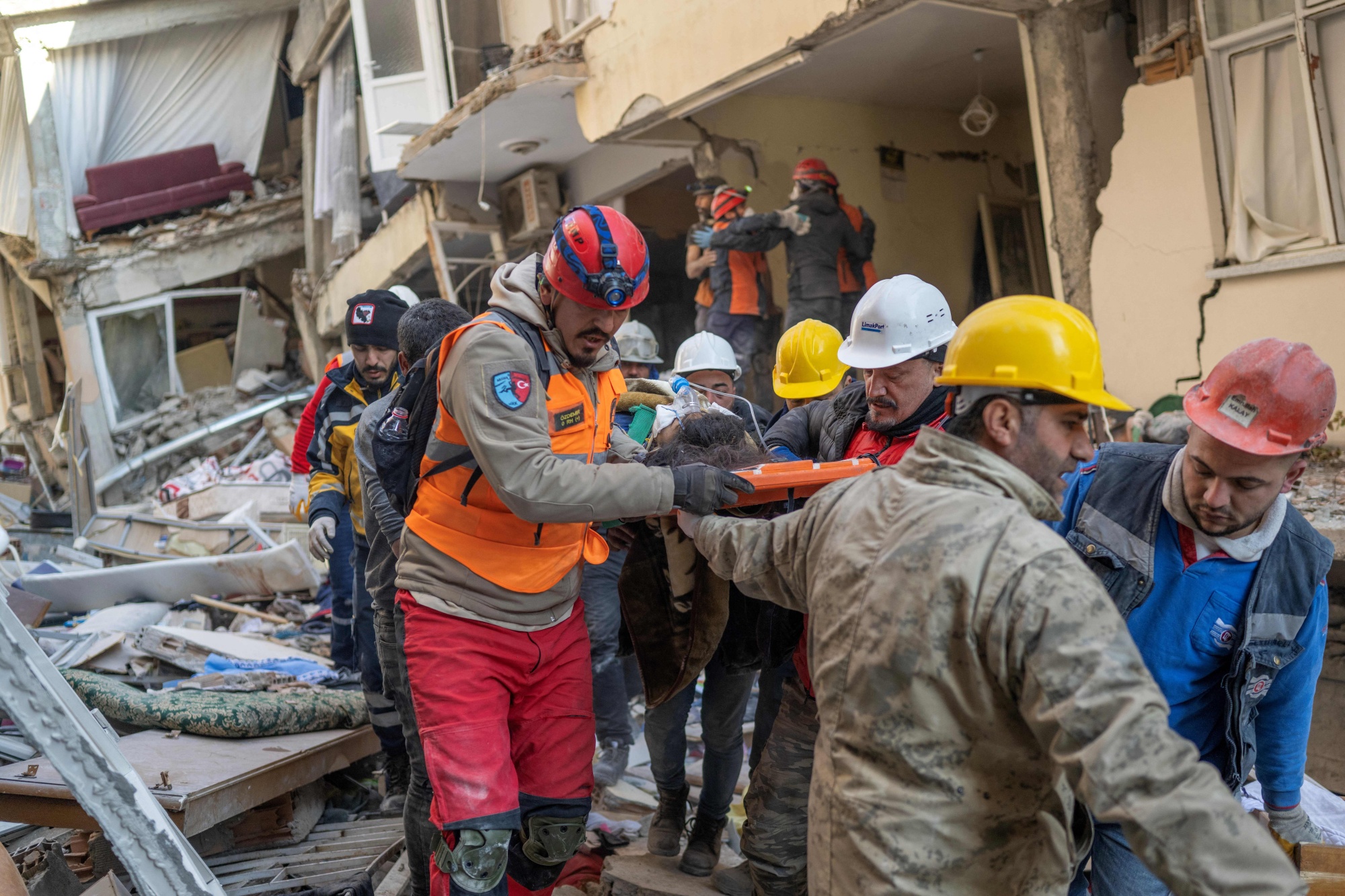 Rescuers transport a survivor from a collapsed building in Hatay, Turkey, on Feb. 9.