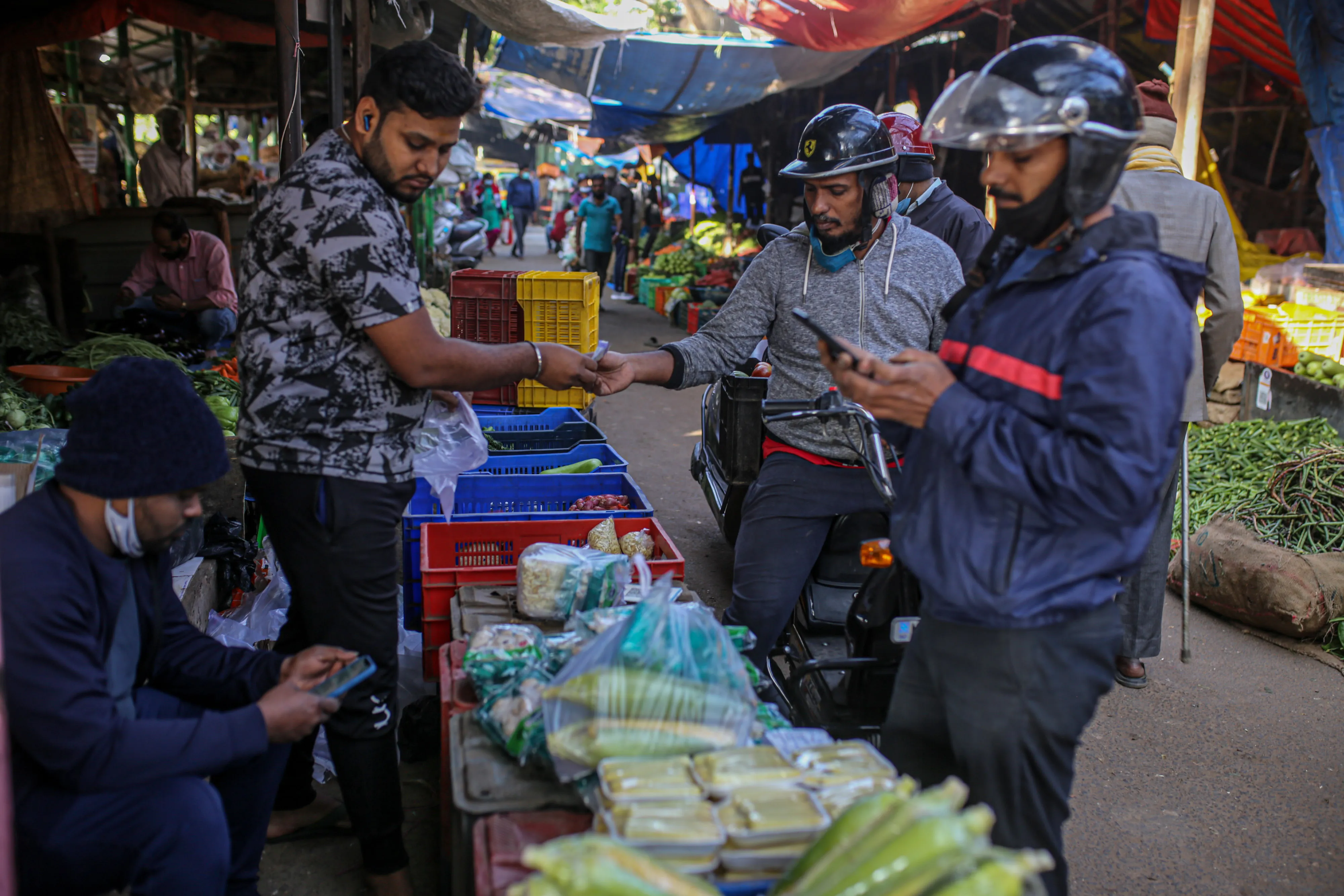 Customers buy vegetables at a wholesale market in Bengaluru, India.