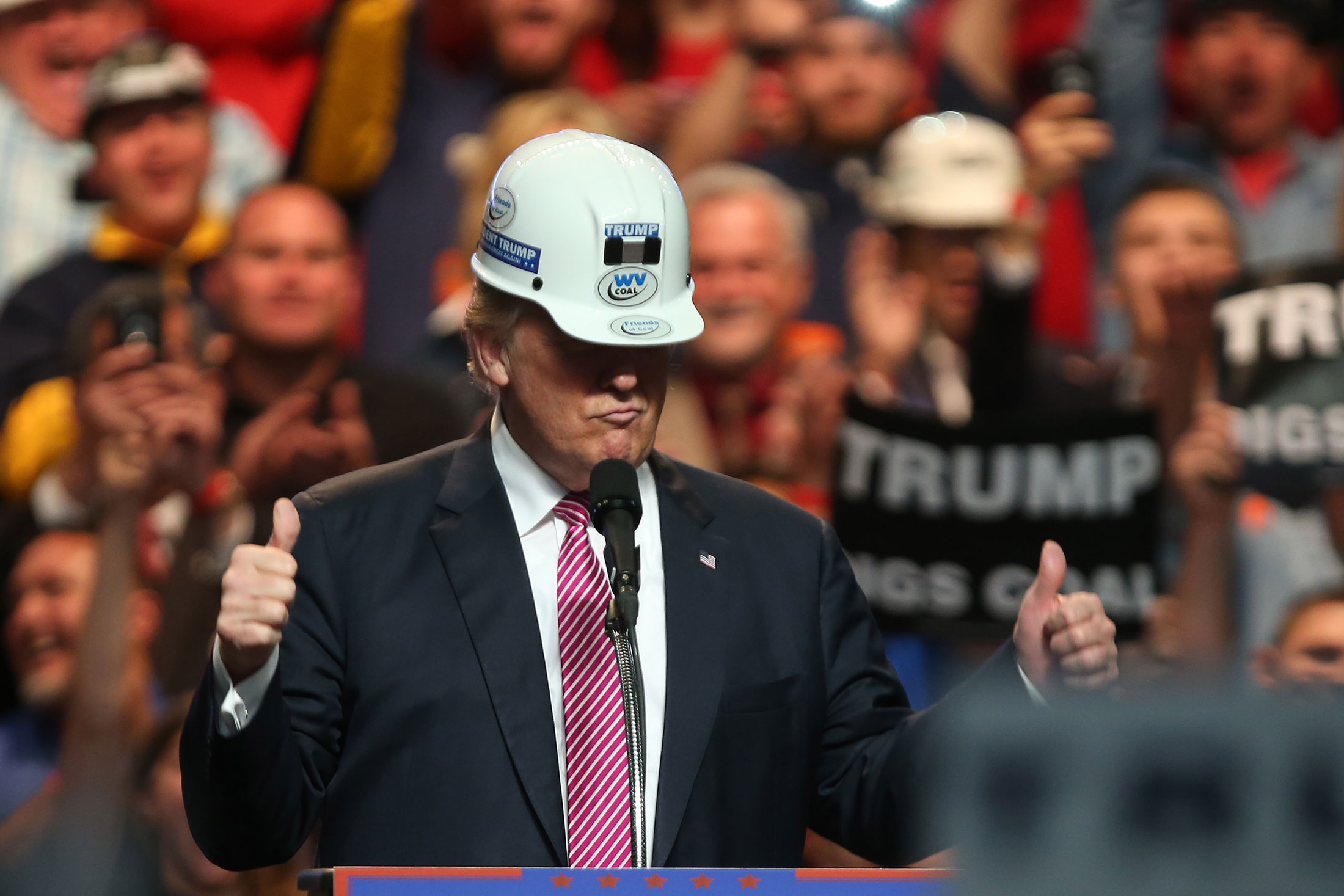 Donald Trump models a hard hat in support of miners during a rally at the Charleston Civic Center in Charleston, West Virginia.