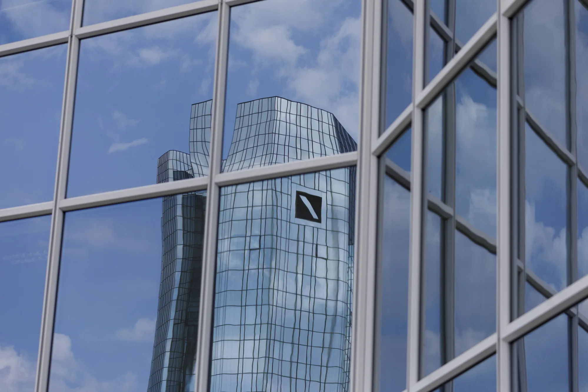 The twin tower&nbsp;headquarters of Deutsche Bank&nbsp;are reflected in the windows of a neighboring office block in Frankfurt.