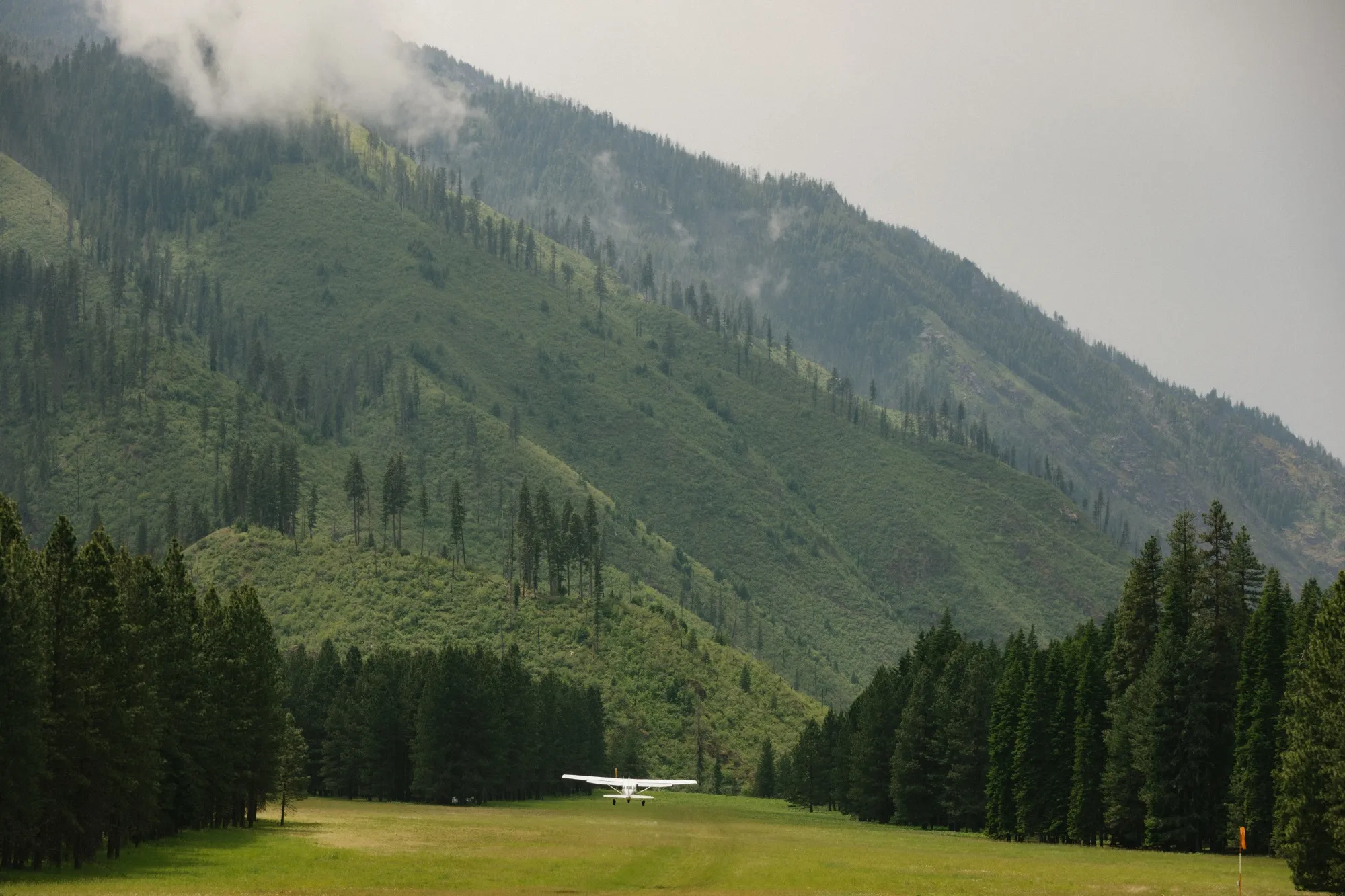 A Cessna U206F Stationair taking off from Moose Creek airstrip after airplane camping.