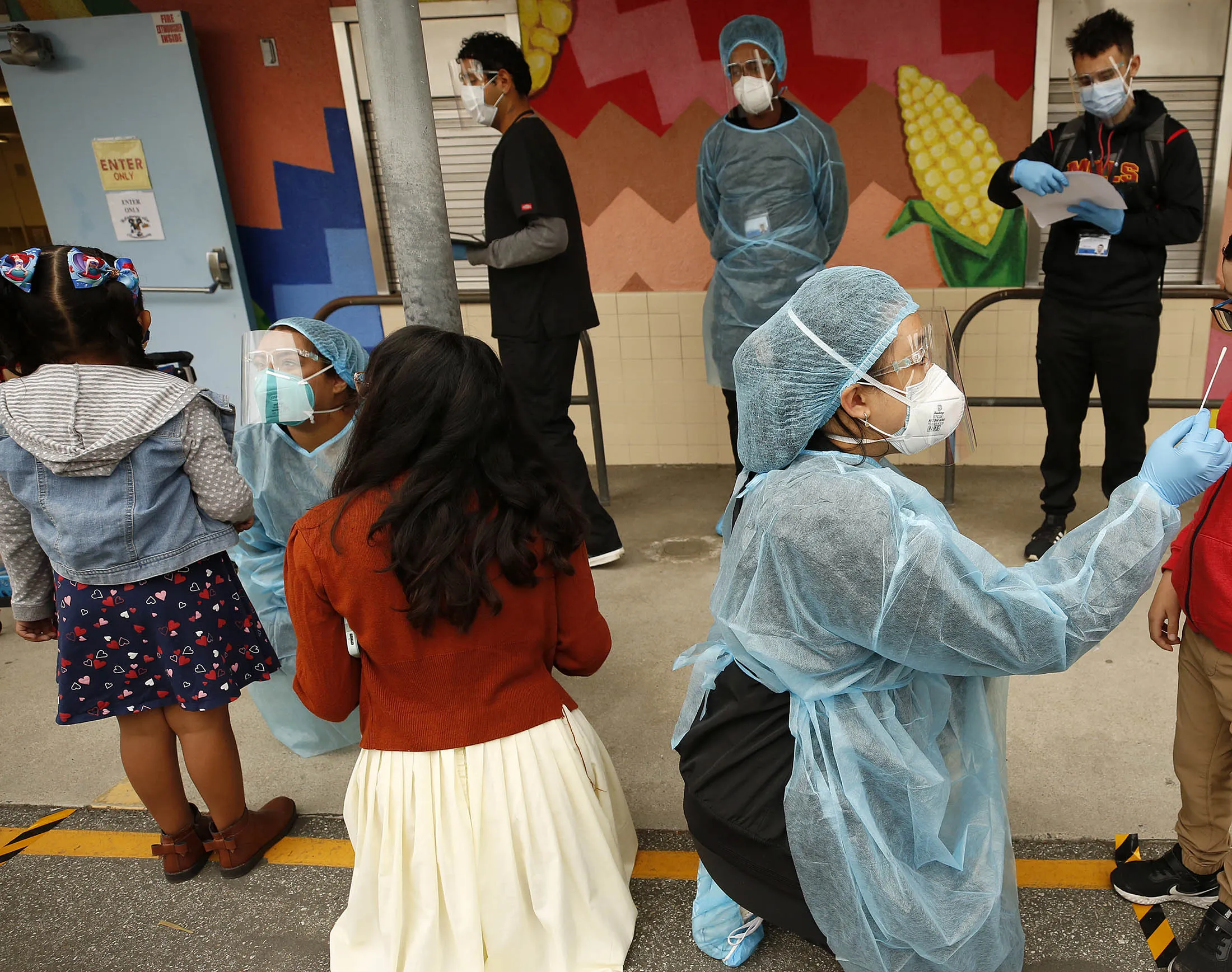 Students receive Covid-19 tests from emergency medical technicians at an elementary school in California.