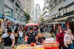 Shoppers walk through a market in Kuala Lumpur, Malaysia.