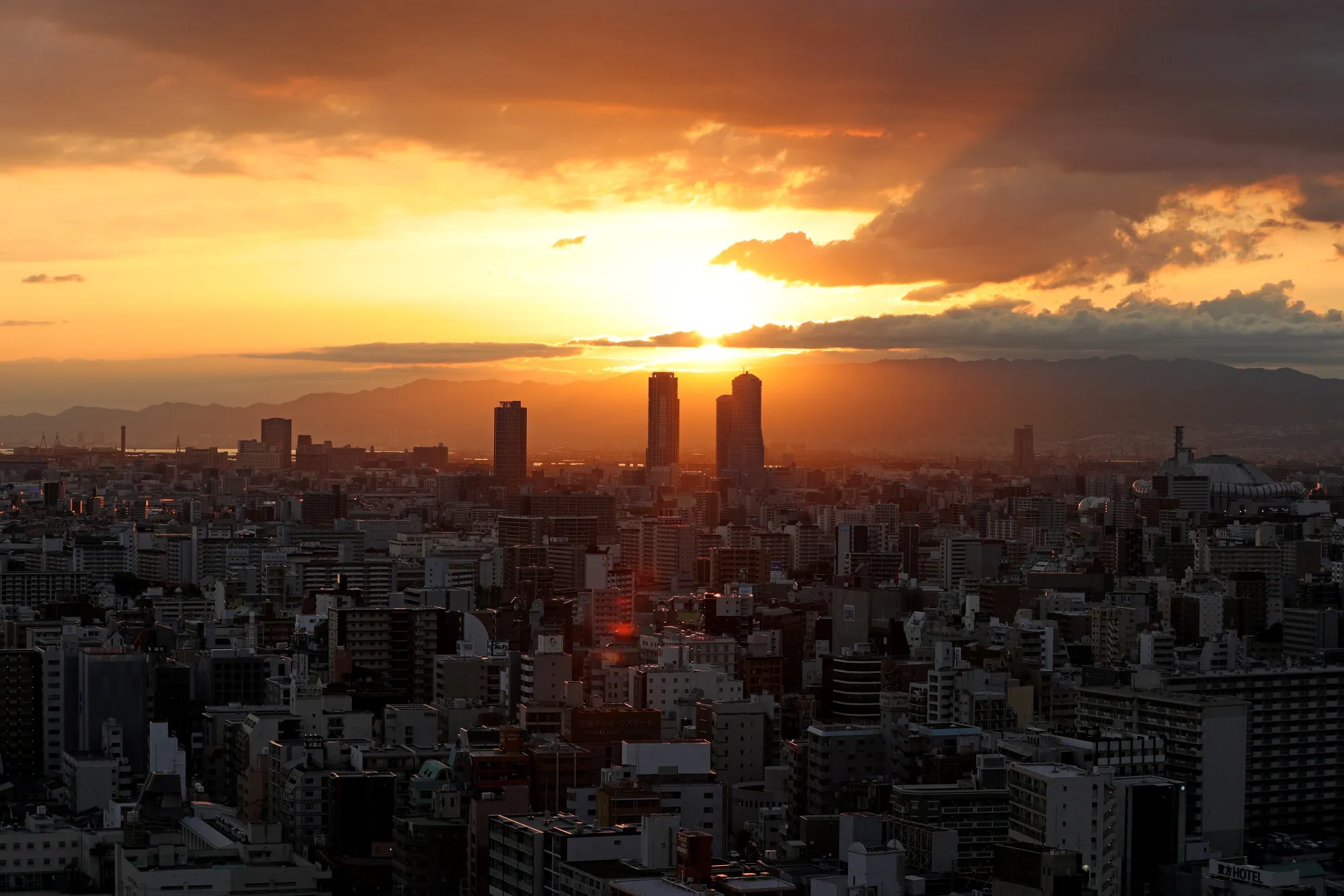 Commercial and residential buildings stand on the skyline at dusk in Osaka, Japan, on&nbsp;May 21.