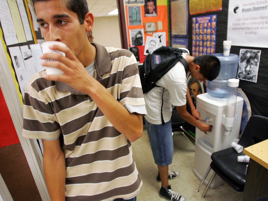  In this 2009 photo, Jesus Lealstripe, left gets a drink of water from a dispenser at Lovell High School in the Central Valley's Cutler, California. 