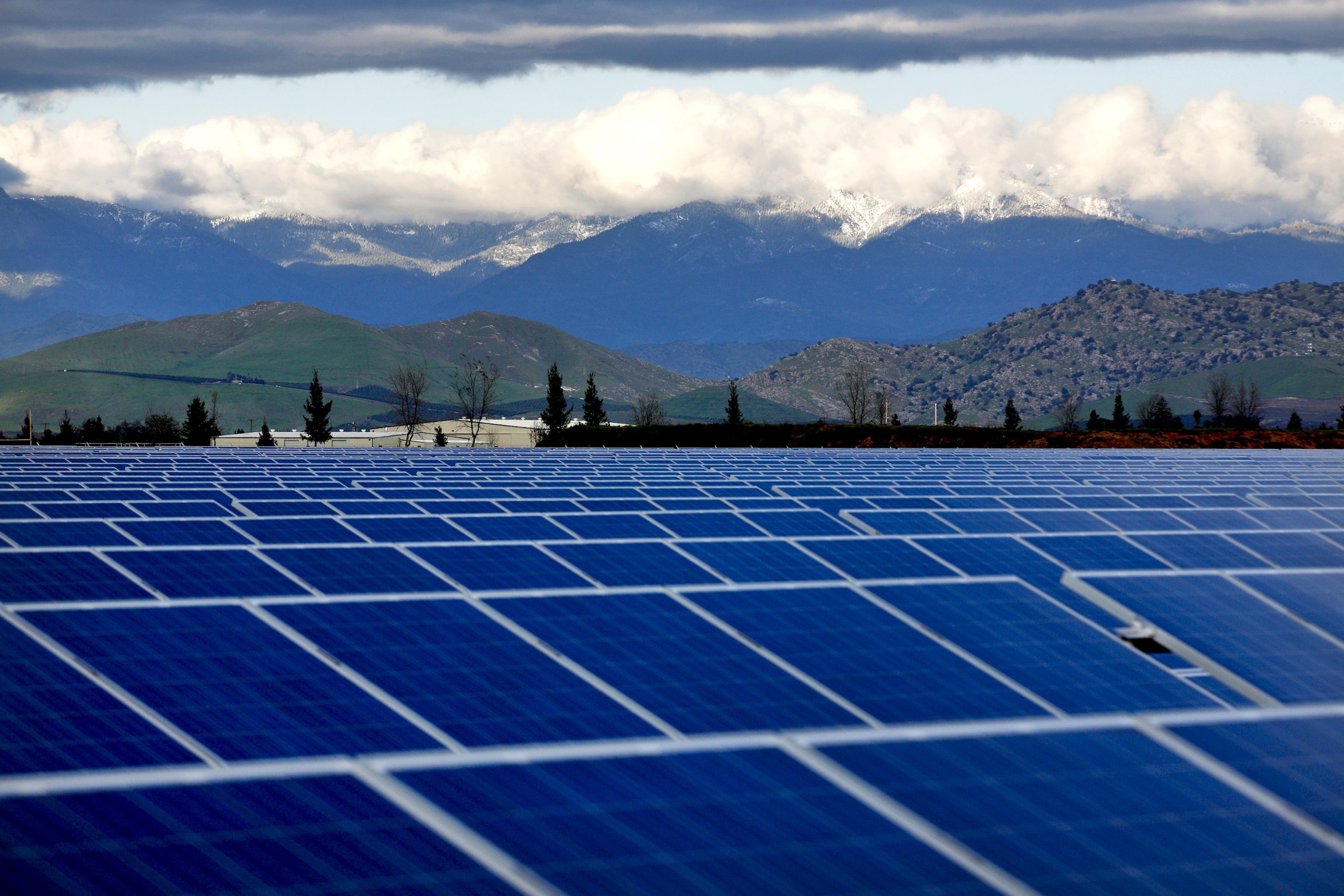 Mountains stand beyond solar modules at the Southern California Edison (SCE) solar array in Porterville, California, U.S., on Thursday, Feb. 17, 2011. The photovoltaic array, which consists of 29,426 solar panels, will be capable of producing 6.7 Megawatts (MW) of renewable energy when it goes online on Feb. 24.
