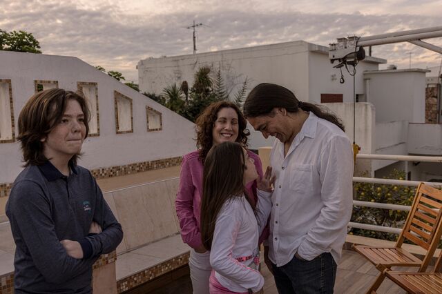Yanina Court and her husband Lionel Vera with their two children laughing outside their home. 