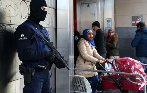 A Belgian police officer stands guard outside the De Brouckere metro station in Brussels, on March 23, 2016.