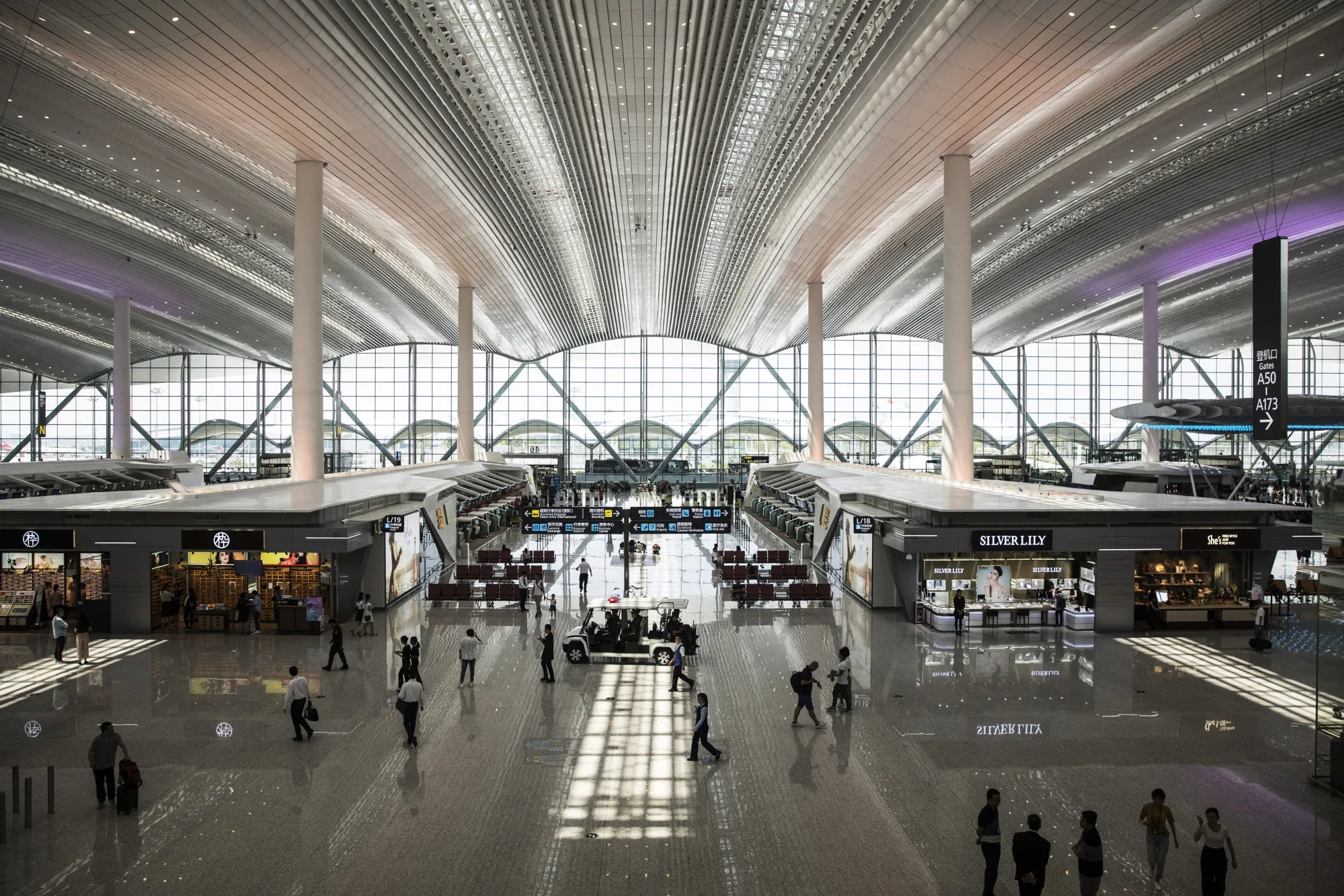 People walk through the departure hall at Terminal 2 of the Guangzhou Baiyun International Airport in Guangzhou, China.