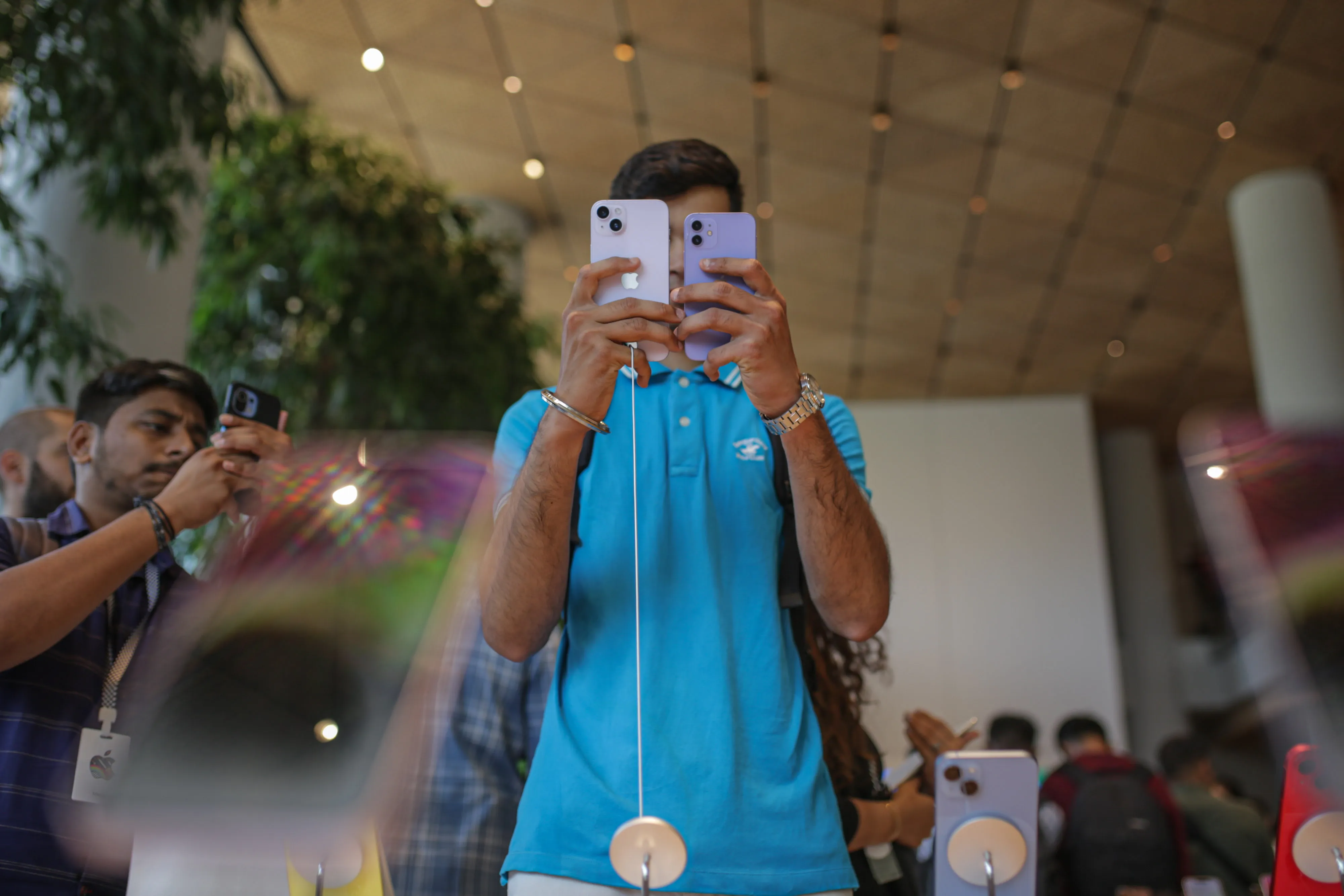 A customer browses iPhones at an Apple store.