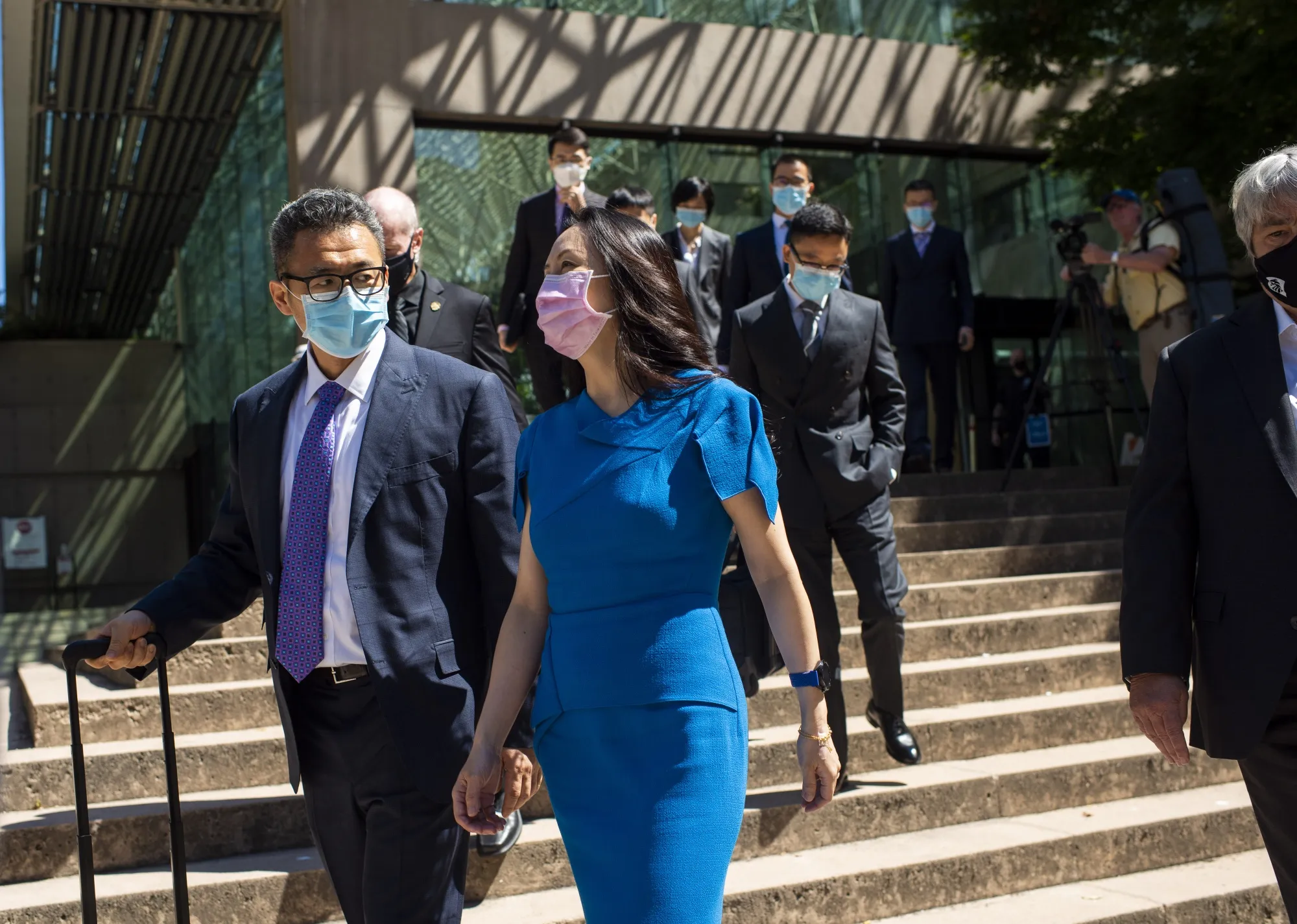 Meng Wanzhou, center, leaves for a lunch break after a morning hearing at the Supreme Court in Vancouver, British Columbia, Canada, on Wednesday, Aug. 4, 2021.