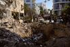 Security and rescue teams inspect the site of an Iranian missile strike in Tel Aviv, on March 24.
