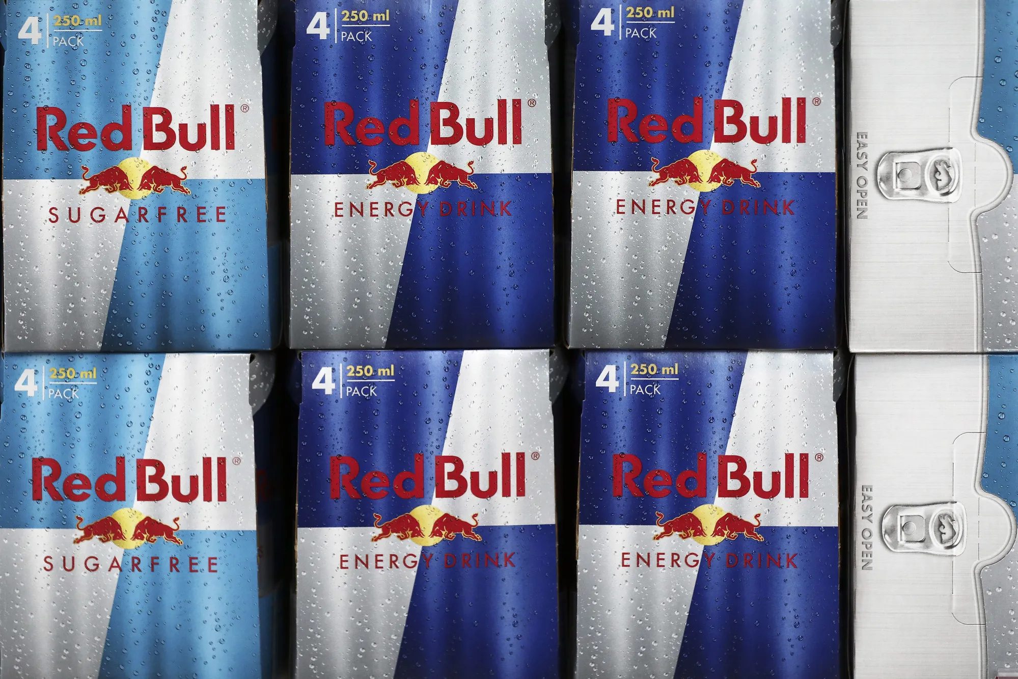 Cans of Red Bull GmbH energy drink sit on display inside a&nbsp;supermarket in Redhill.