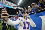 Buffalo Bills quarterback Josh Allen talked a selfie after an NFL football game against the Detroit Lions, Thursday, Nov. 24, 2022, in Detroit. (AP Photo/Paul Sancya)