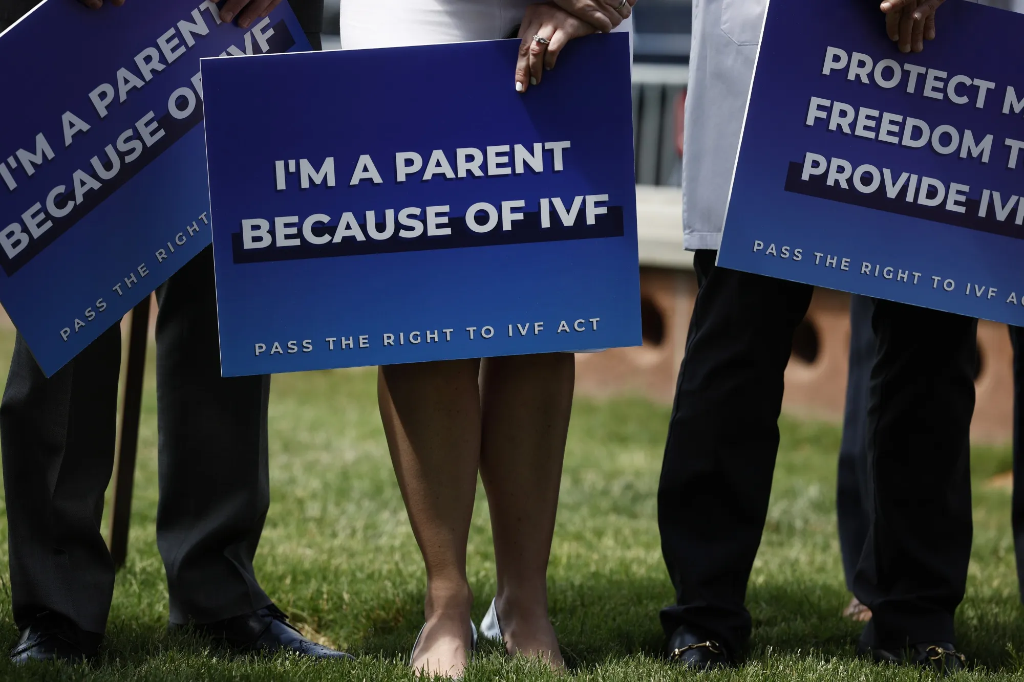 Medical workers and IVF patients during a news conference on access to in vitro fertilization treatments.
