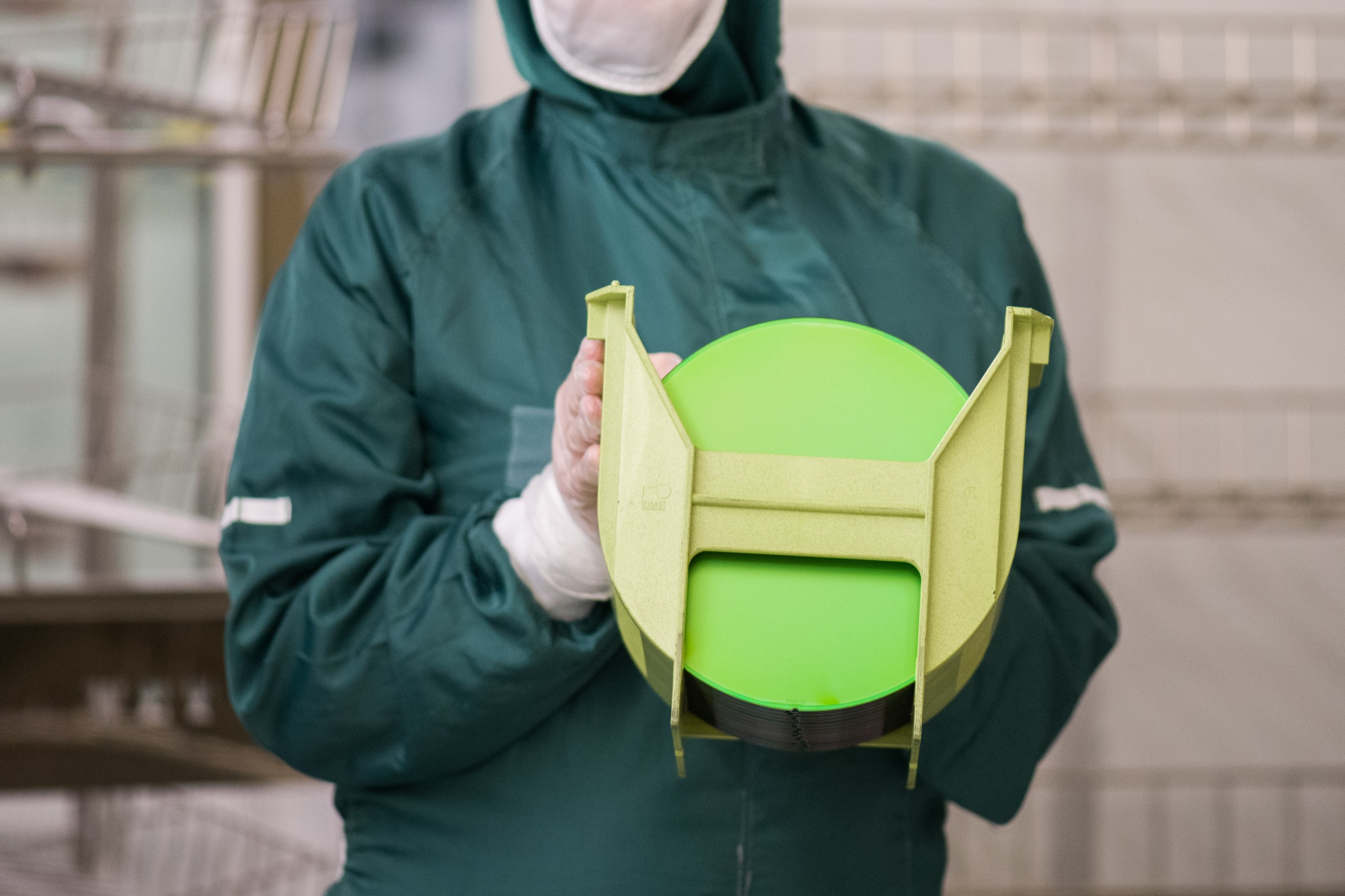 An employee holds a rack of 200 millimetre silicon wafers at the X-Fab Silicon Foundries SE semiconductor plant in Corbeil-Essonnes, France, on Tuesday, June 1, 2021. Shortages in the semiconductor industry, which have already slammed automakers and consumer electronics companies, are getting even worse, complicating the global economy’s recovery from the coronavirus pandemic.