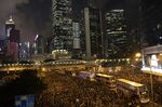 Buses slowly move through the crowd of protesters during a rally in Hong Kong, China, on Sunday, June 16, 2019.