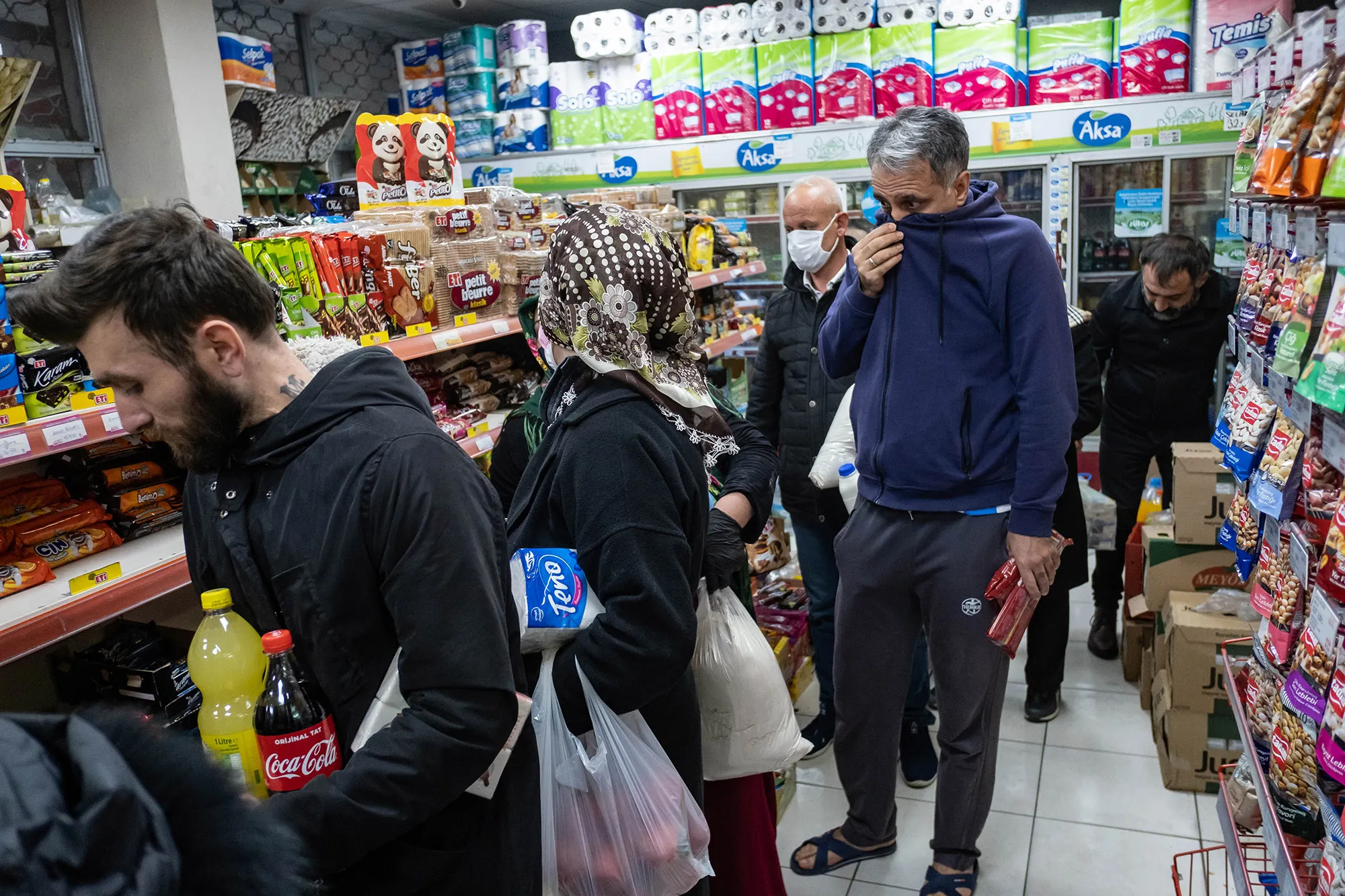 People queue at shops for food and supplies shortly before the curfew in Istanbul, on April 10.