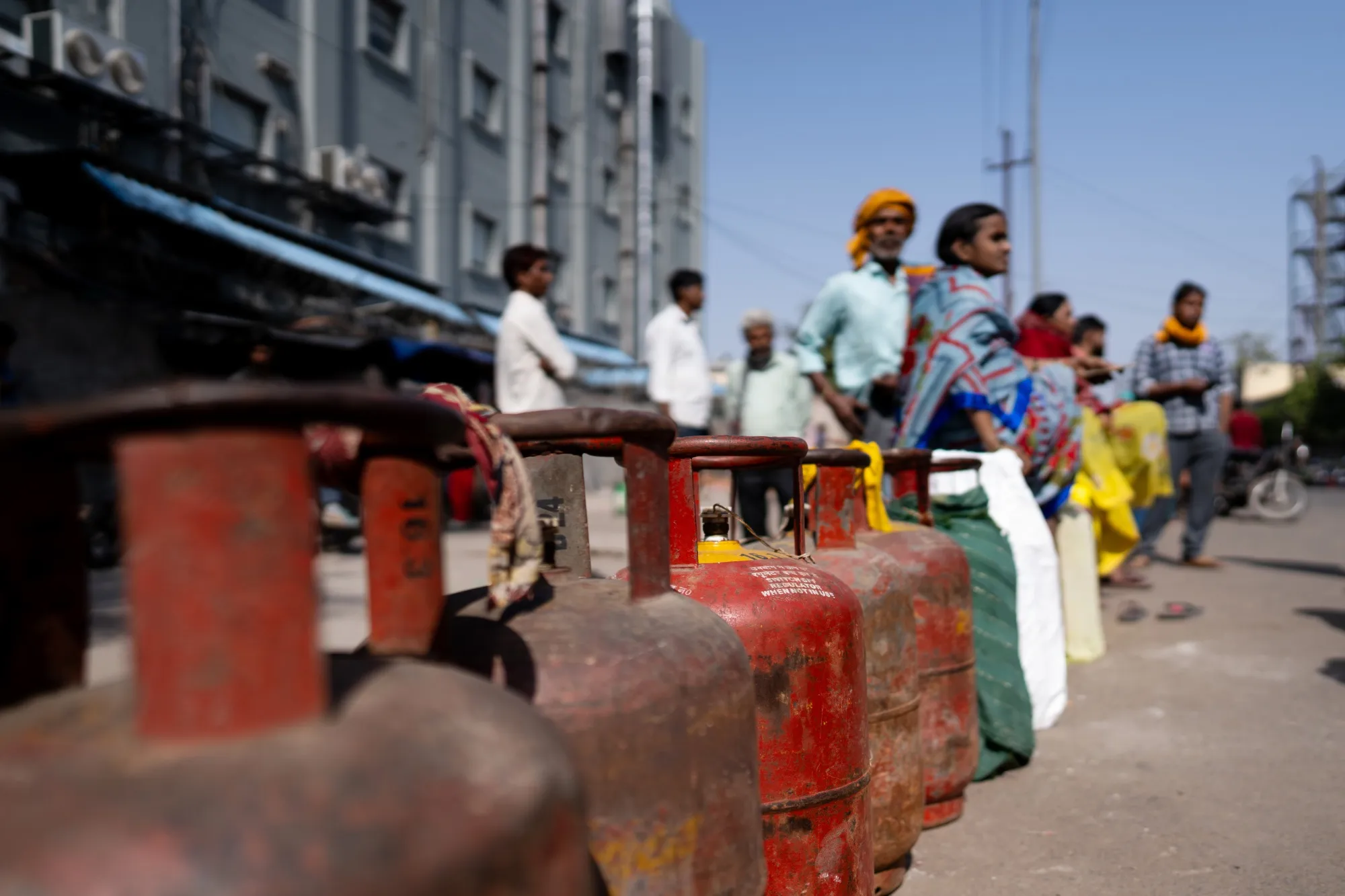 Buyers queue for liquefied petroleum gas at a depot in Noida, Uttar Pradesh, India.