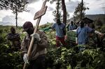 Health workers carry a coffin containing a victim of Ebola virus on May 16, 2019 in Butembo, Democratic Republic of Congo..