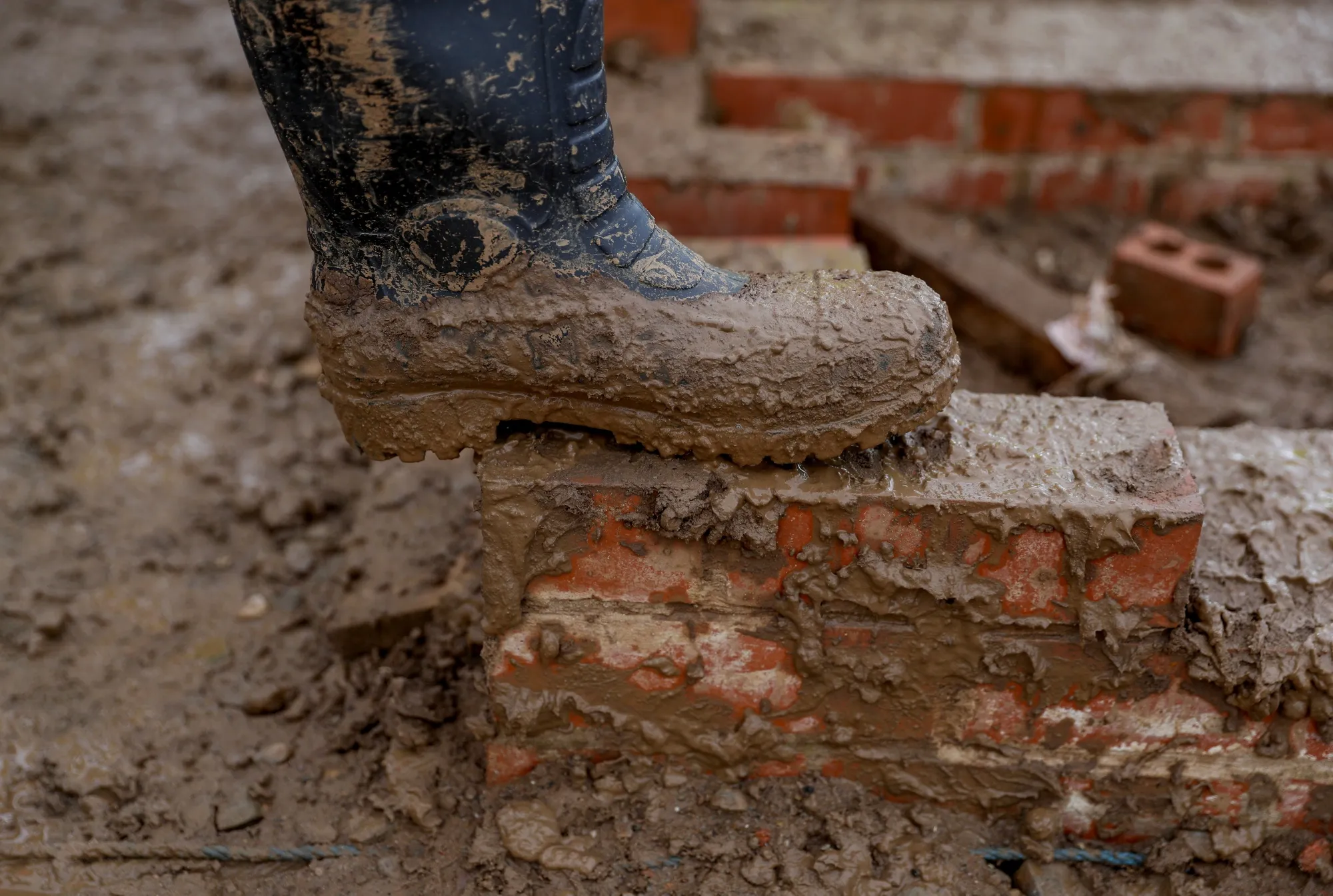 Muddy boots on a construction site.