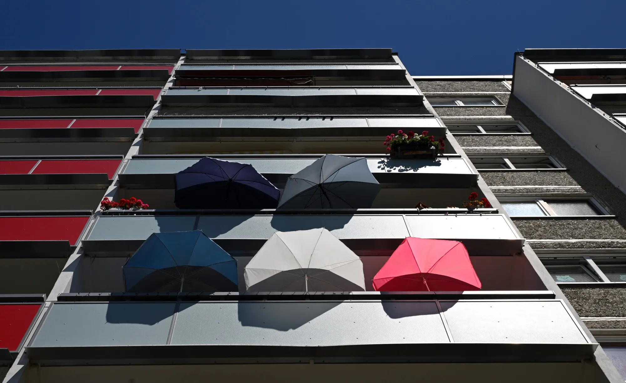 Residents of a prefabricated building&nbsp;use parasols to protect their homes from the heat in Jena, Germany in July.