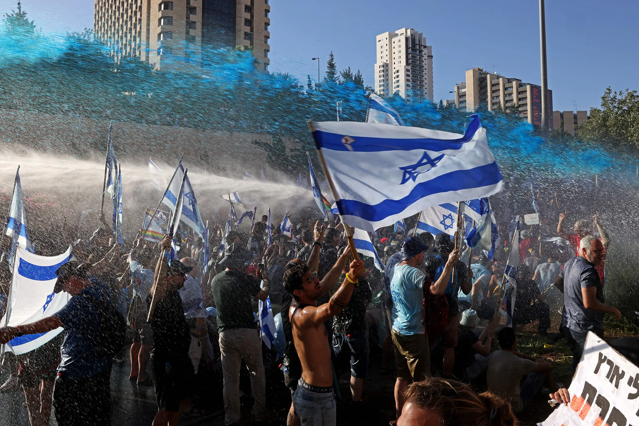 Israeli security forces use a water cannon to disperse demonstrators blocking the entrance of the Knesset, Israel’s parliament, on July 24.