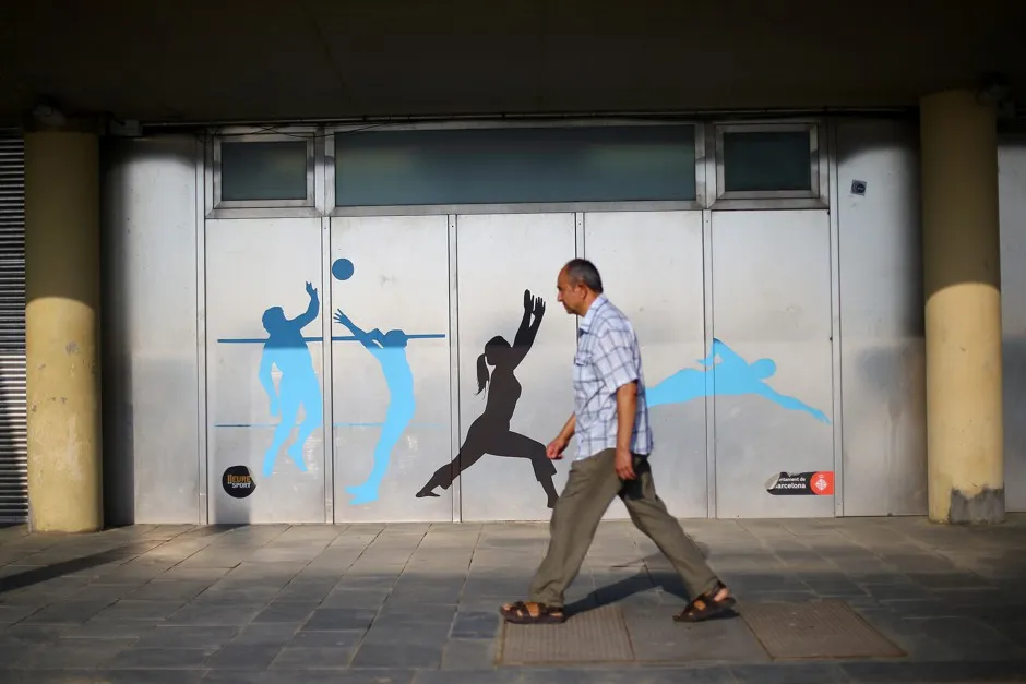 A man walks along a sidewalk in Barcelona. The city's plan to implement more car-free areas and boost pedestrian space could have a major public health payoff, a new study says.