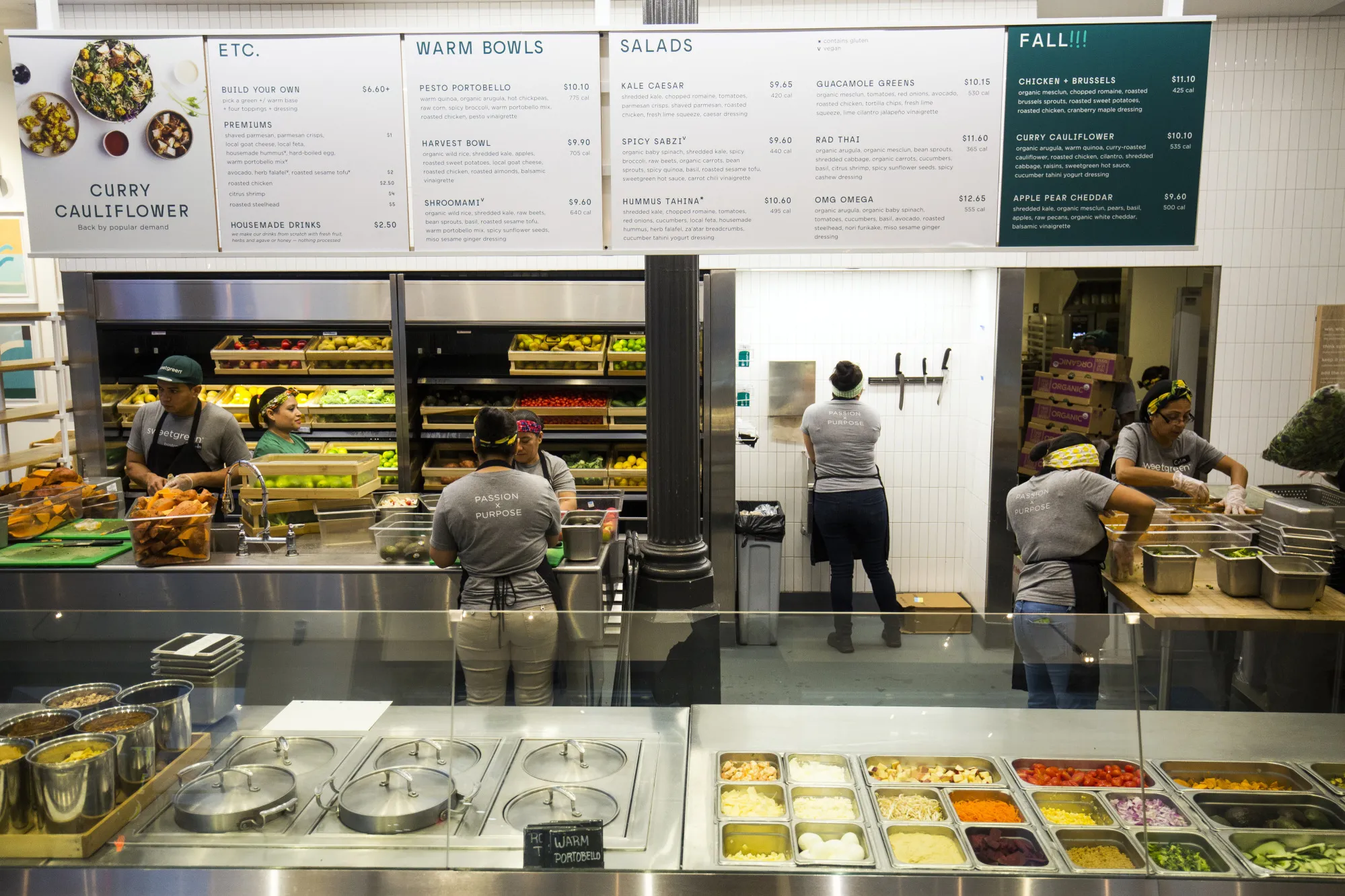Workers prepare food inside a Sweetgreen Inc. restaurant in Boston.