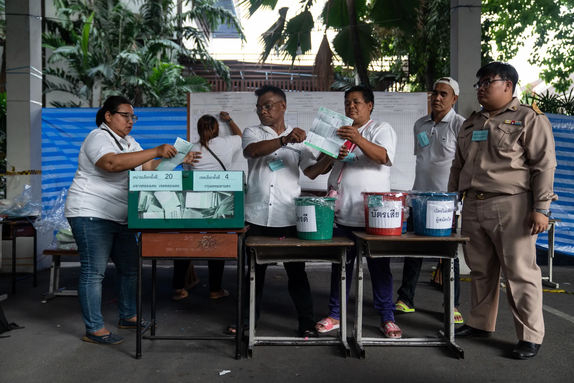 Officials count ballot papers for a general election at a counting center in Bangkok, Thailand, on Sunday, March 24, 2019.&nbsp;
