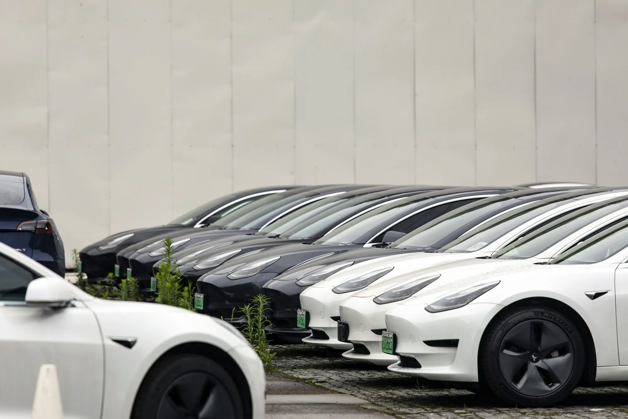 Tesla Inc. Model 3 electric vehicles near one of the automaker's dealership in Shanghai, China.