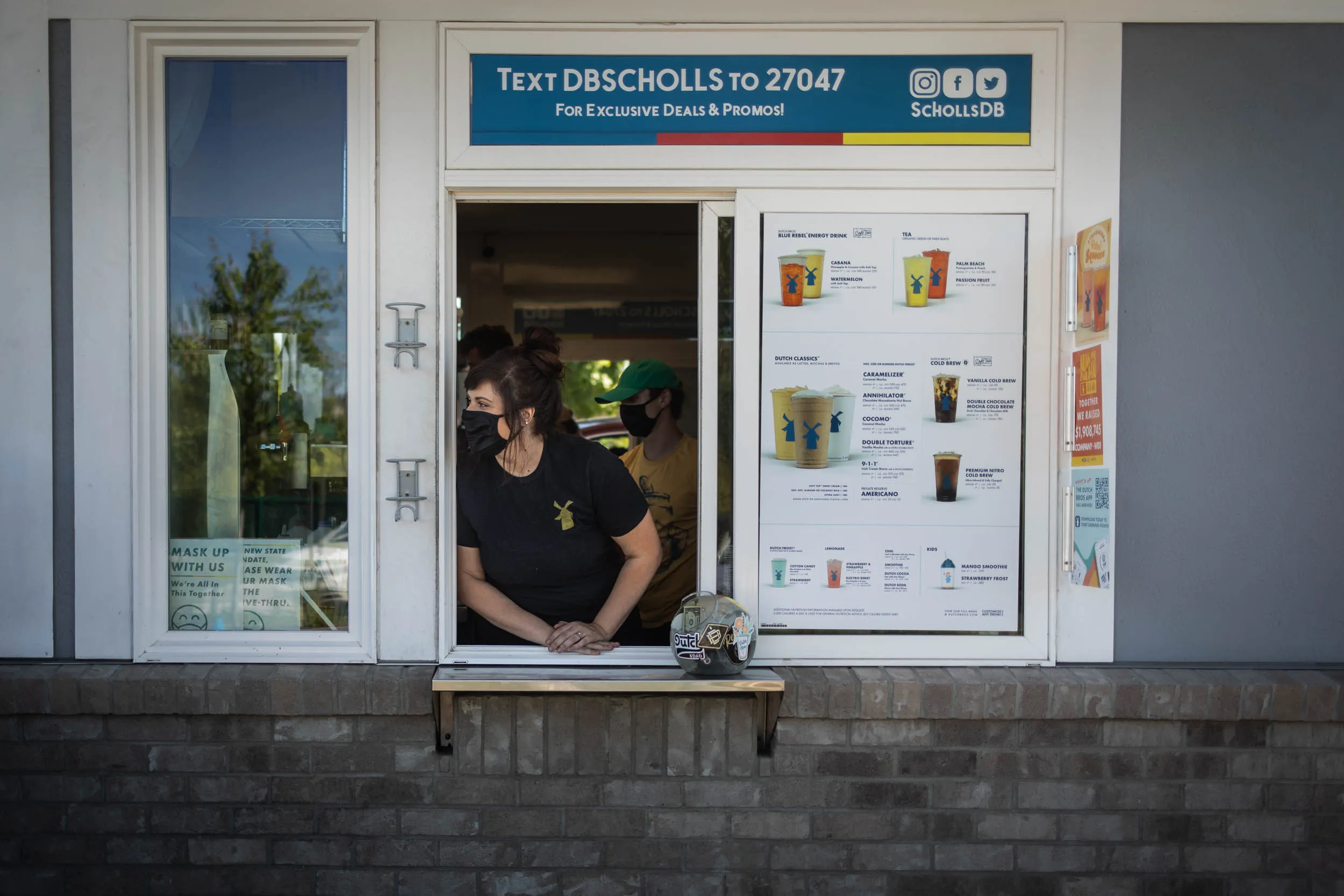 A barista waits at the drive-through window of a Dutch Bros. Coffee location in Beaverton, Oregon, U.S.