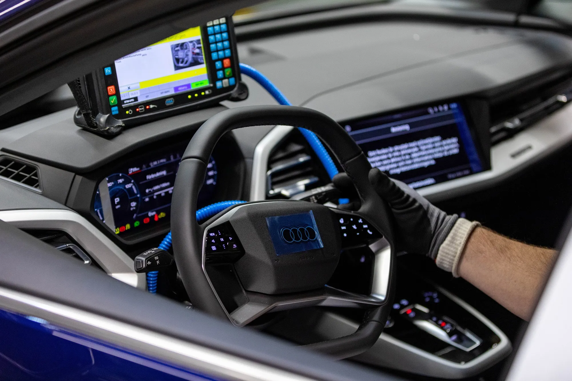 An employee runs a diagnostic test on an Audi electric vehicle.&nbsp;