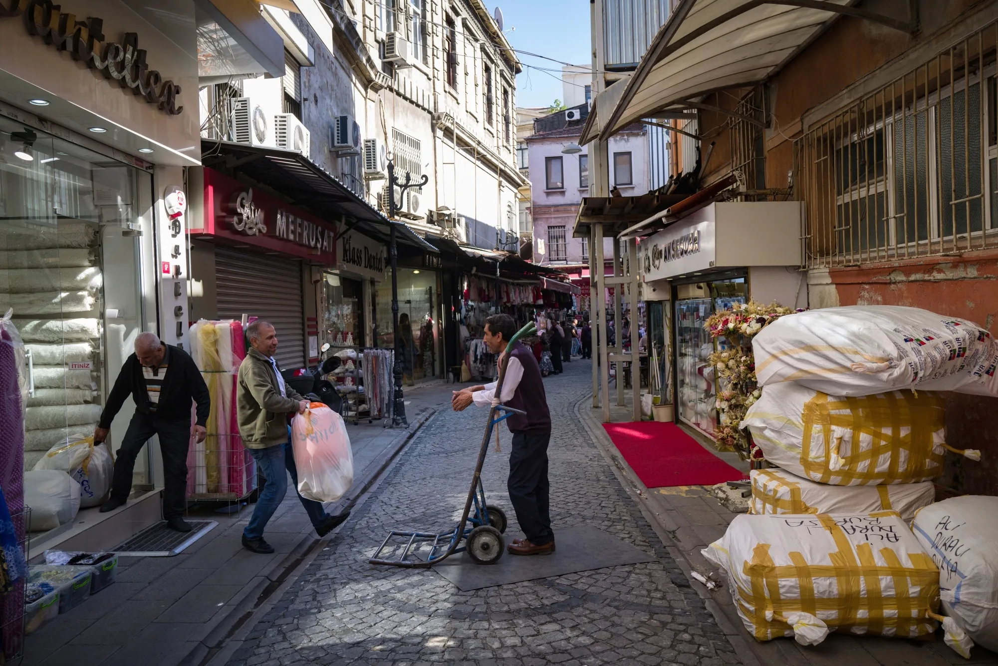 Workers move goods from a store in the Eminonu district of Istanbul.